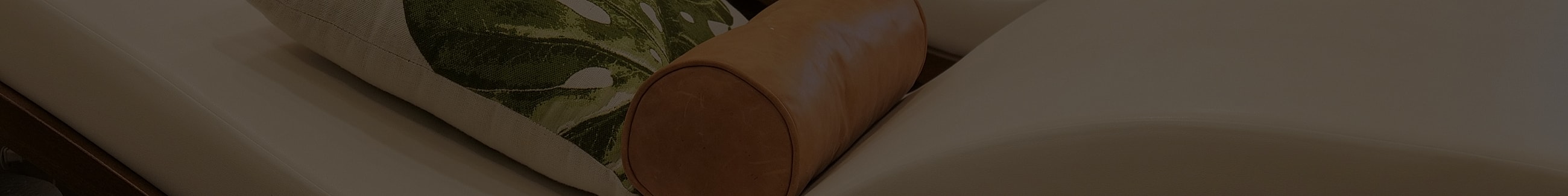 Cozy sofa with decorative cushion and leather detail