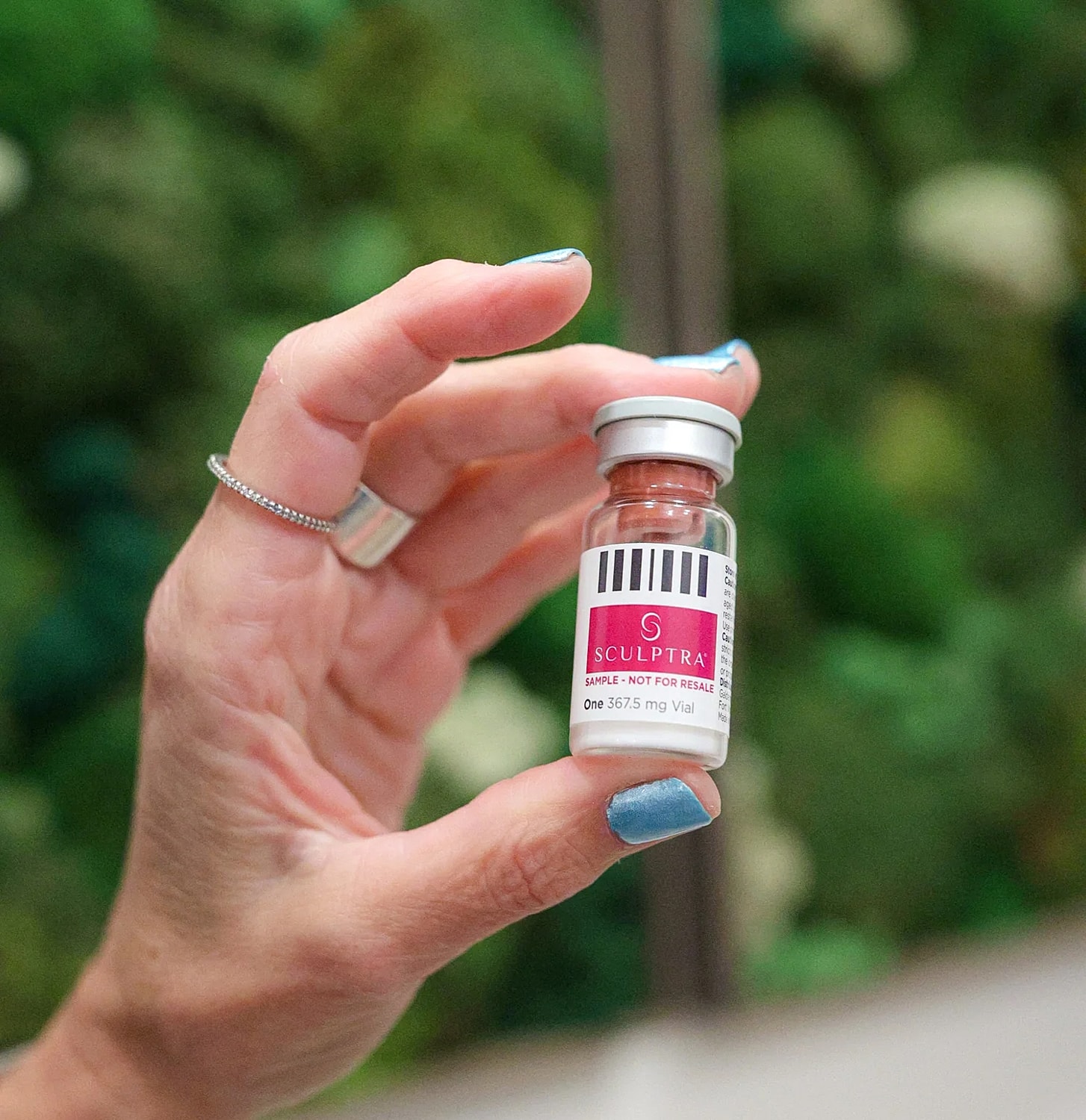 Woman holding a blue and silver object.