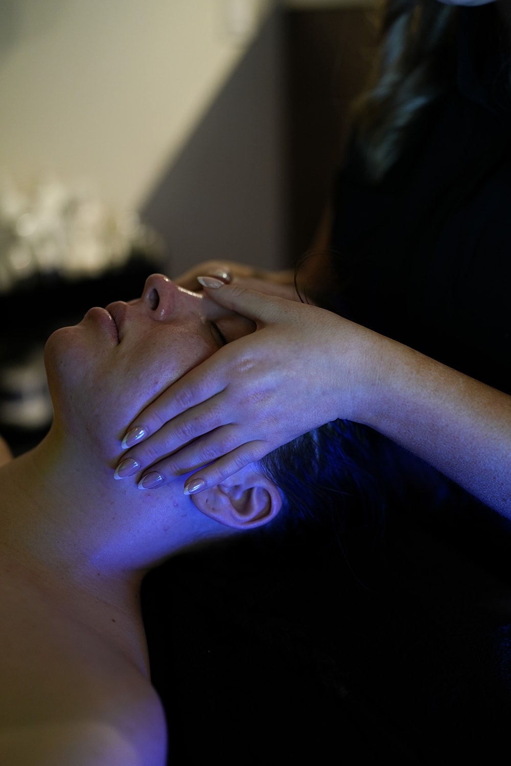 Facial massage in a calm spa setting.