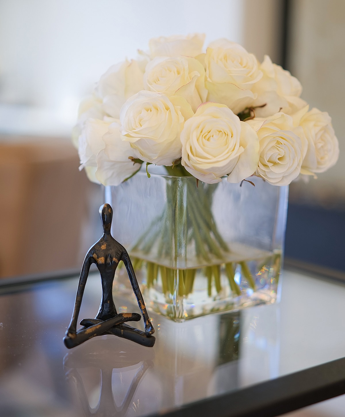 Minimalist sculpture with white rose bouquet.
