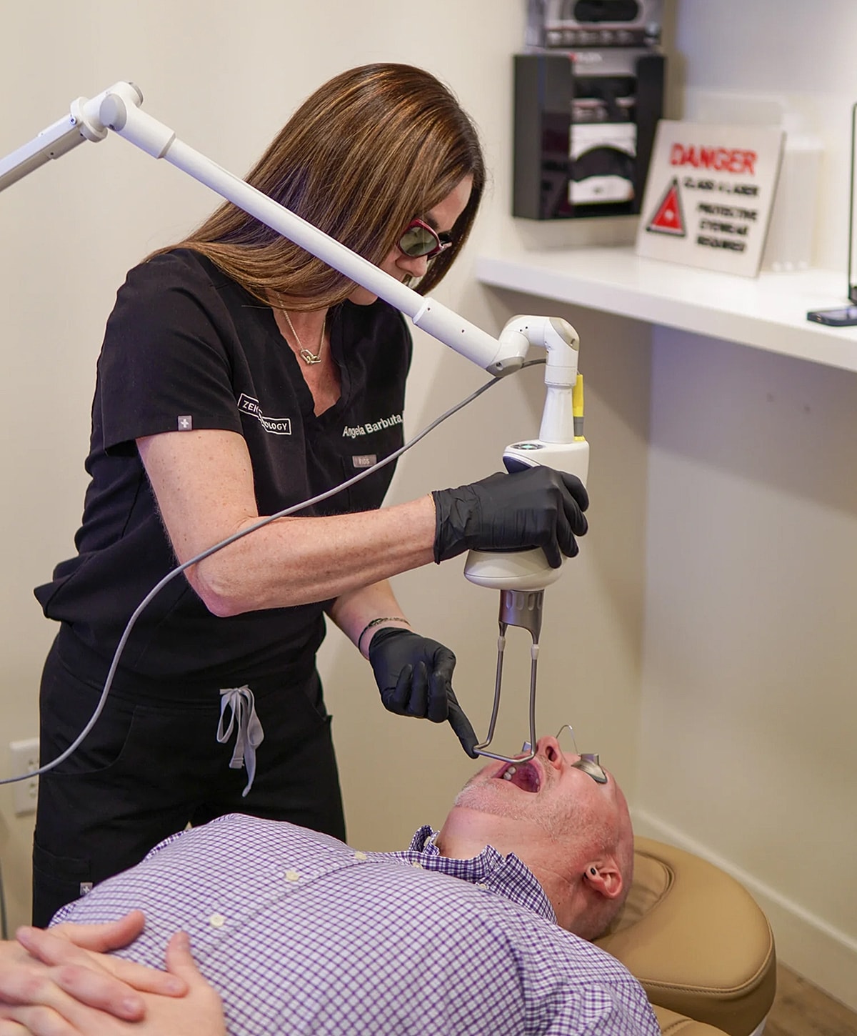 Dental professional performing treatment on a patient.