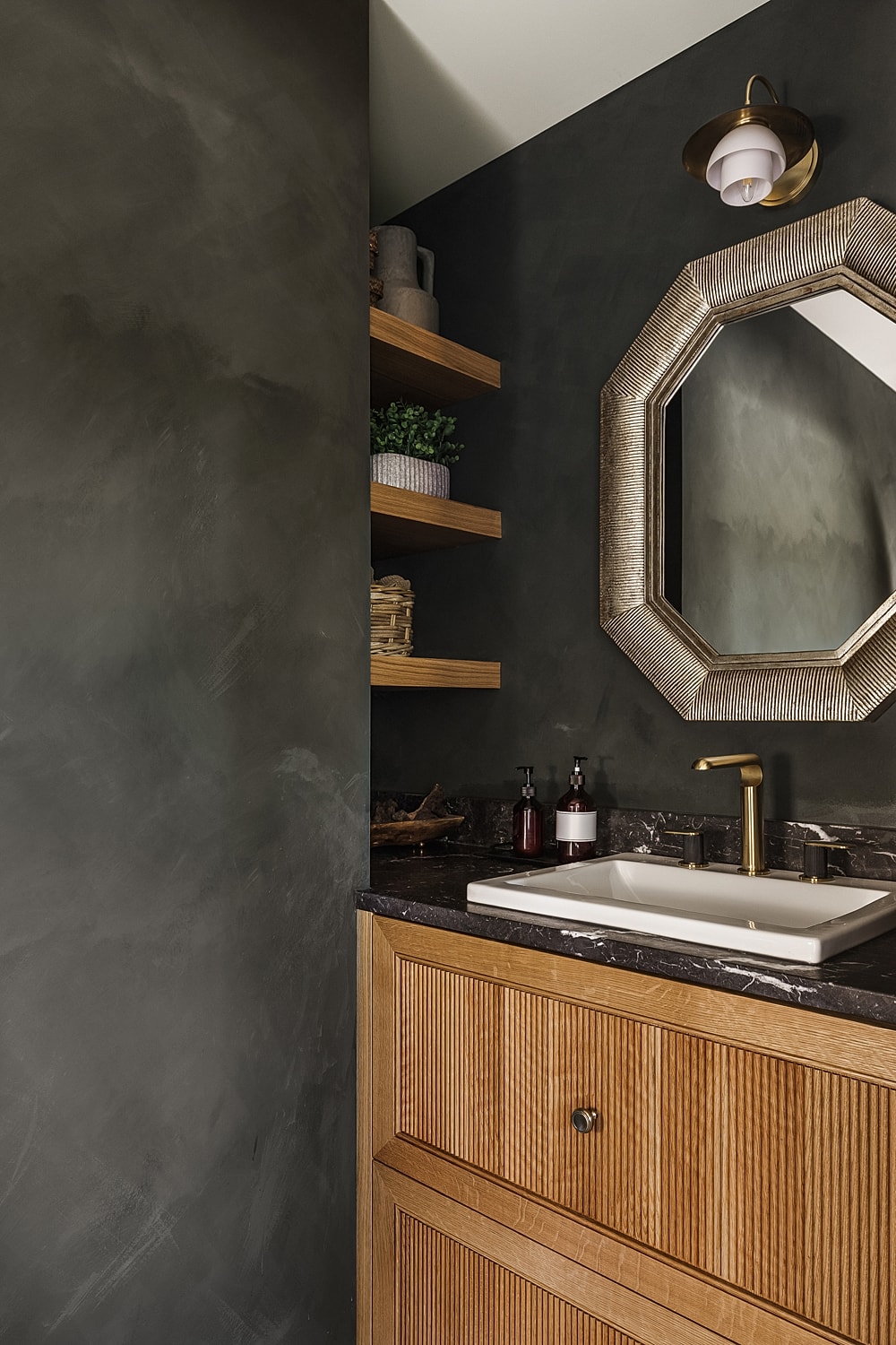 Modern bathroom with dark walls and wooden accents.