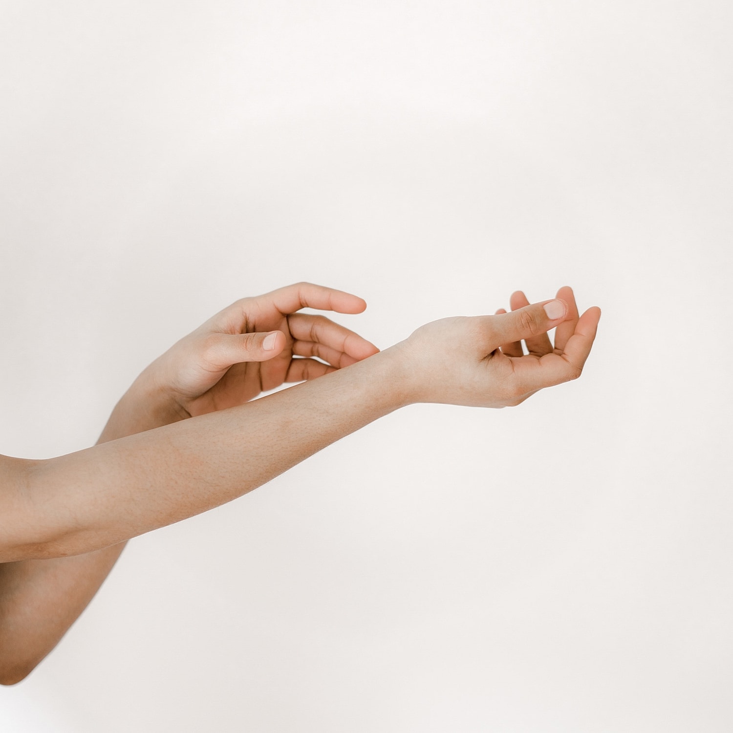Hands reaching out against a neutral background