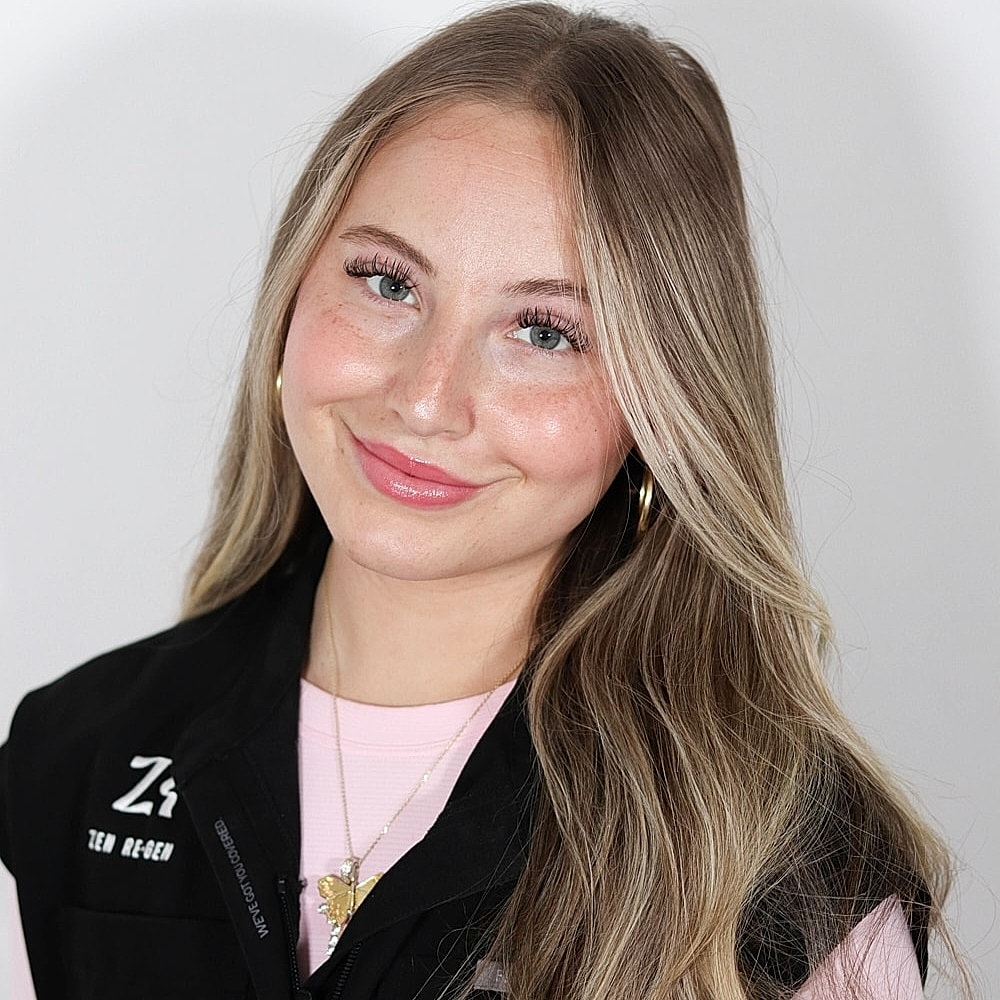 Smiling woman with long, wavy blonde hair.