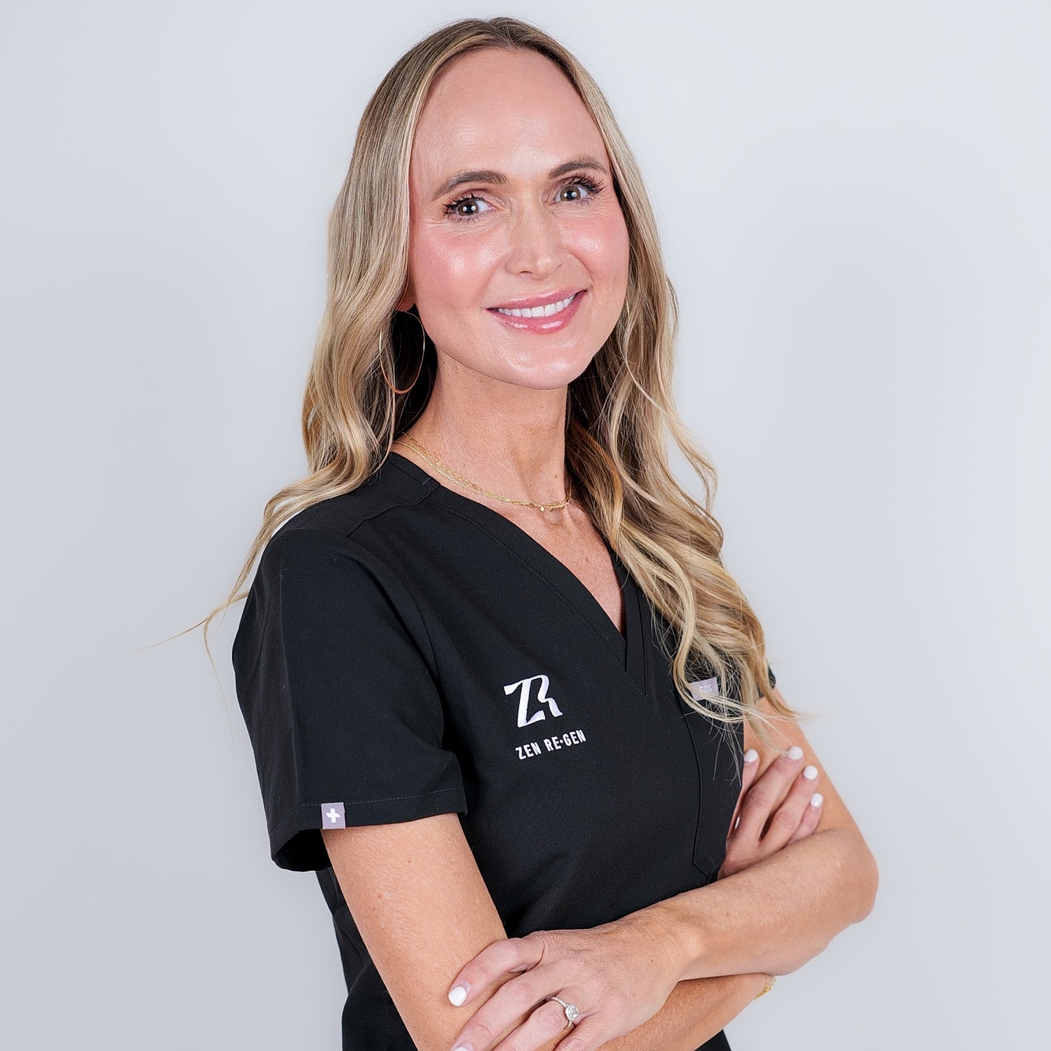 Smiling professional in medical attire.