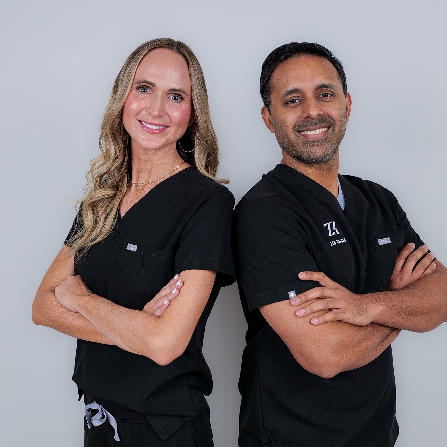Smiling medical professionals in black scrubs.