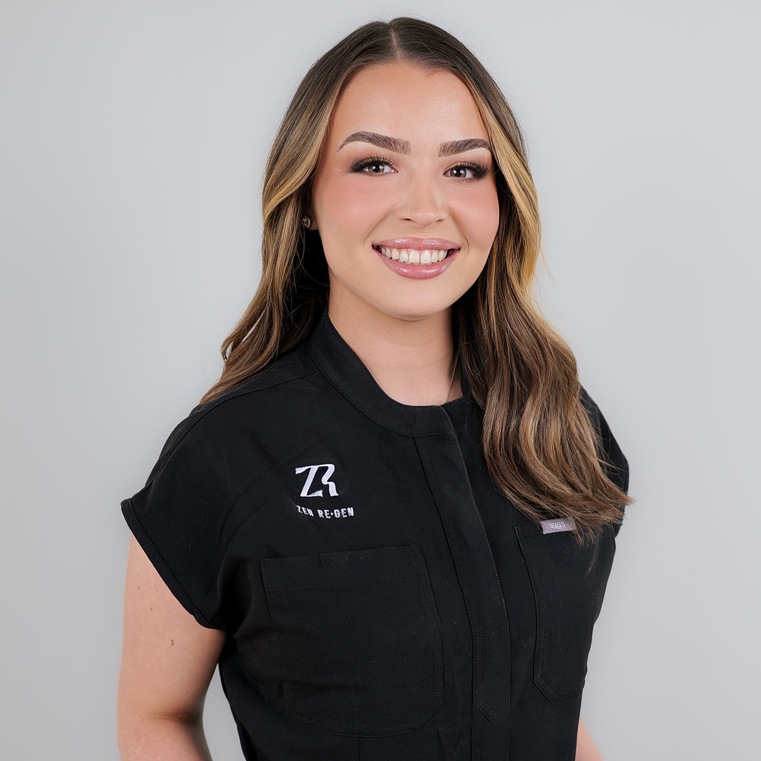 Smiling woman in black professional attire.