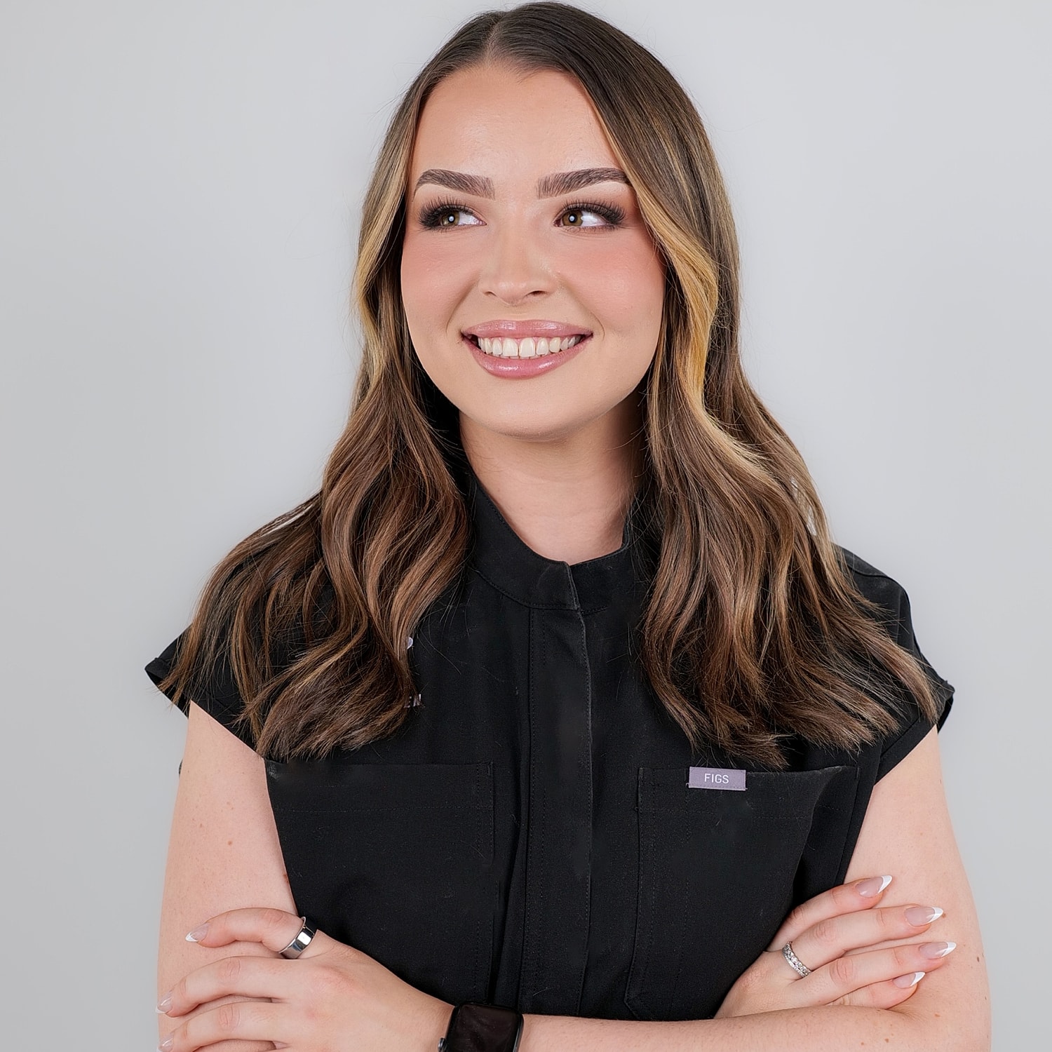 Smiling woman with long hair in black shirt.
