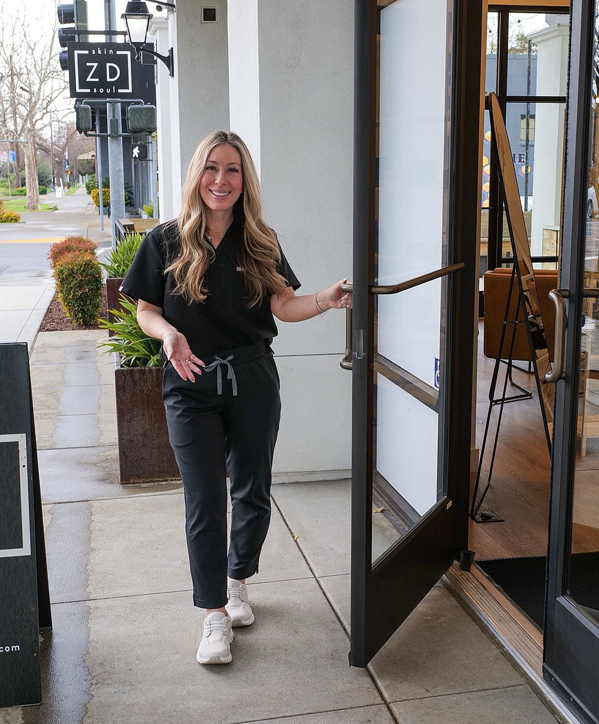 Smiling woman entering a skincare business.