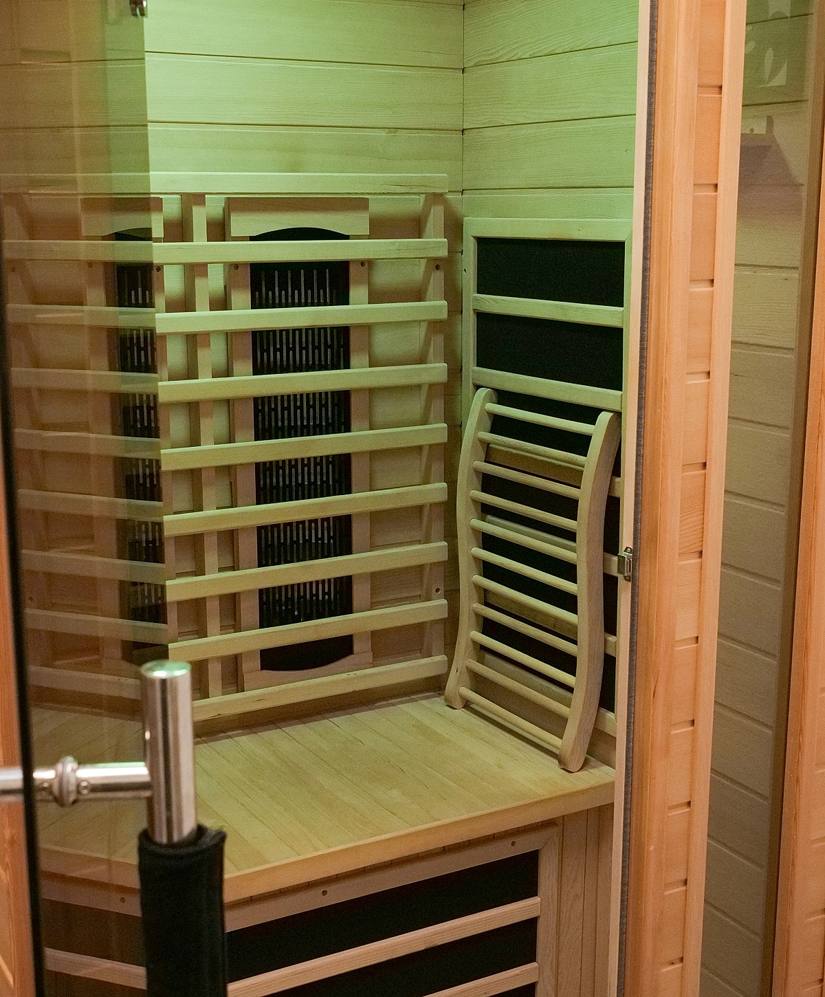Wooden sauna interior with seating and equipment.