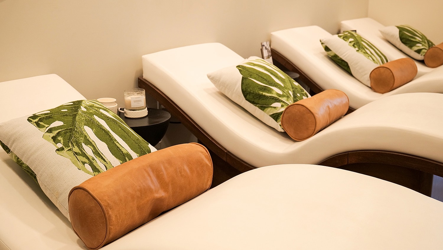 Relaxing spa seating with tropical-themed cushions.
