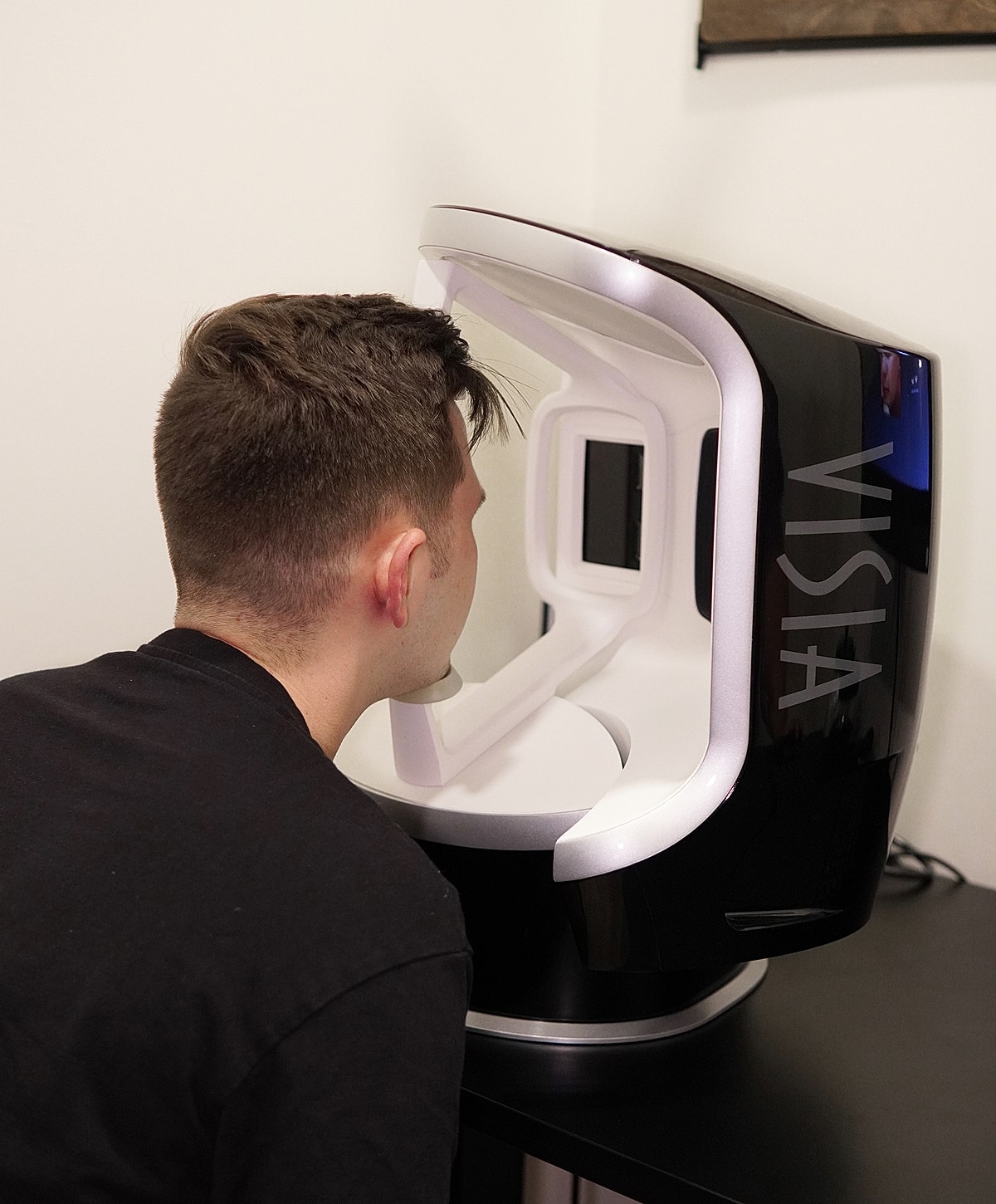 Person using a high-tech facial scanning device.
