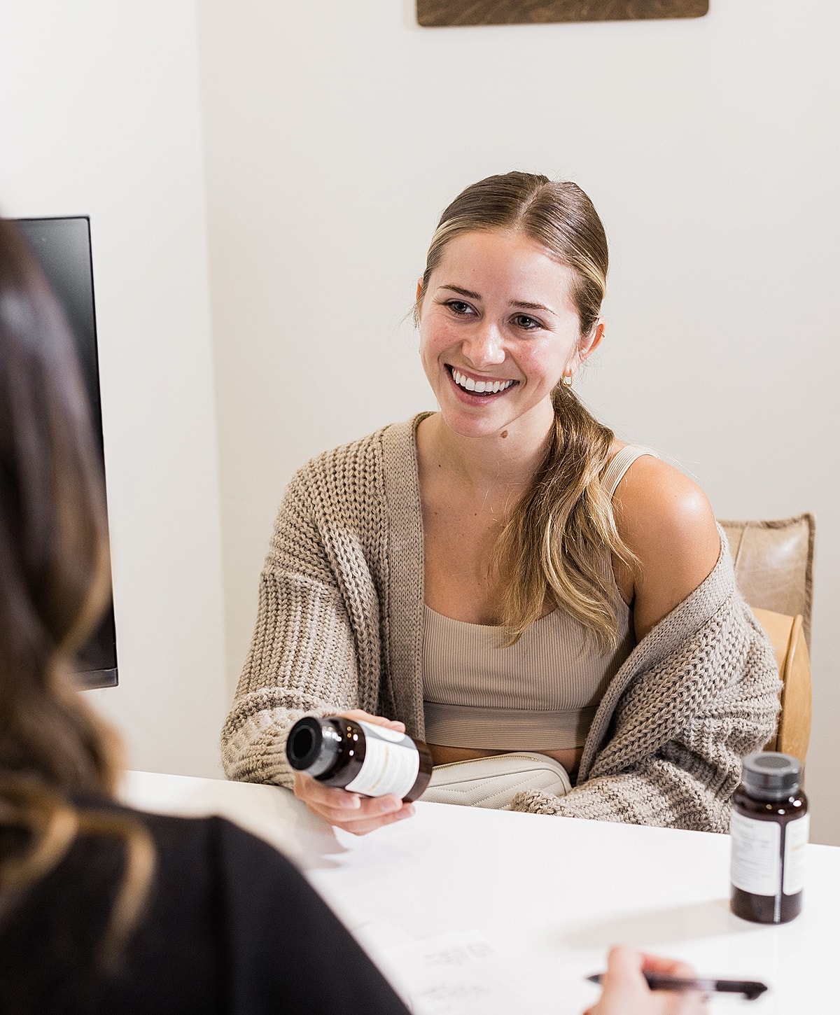 Woman smiling while discussing health products.