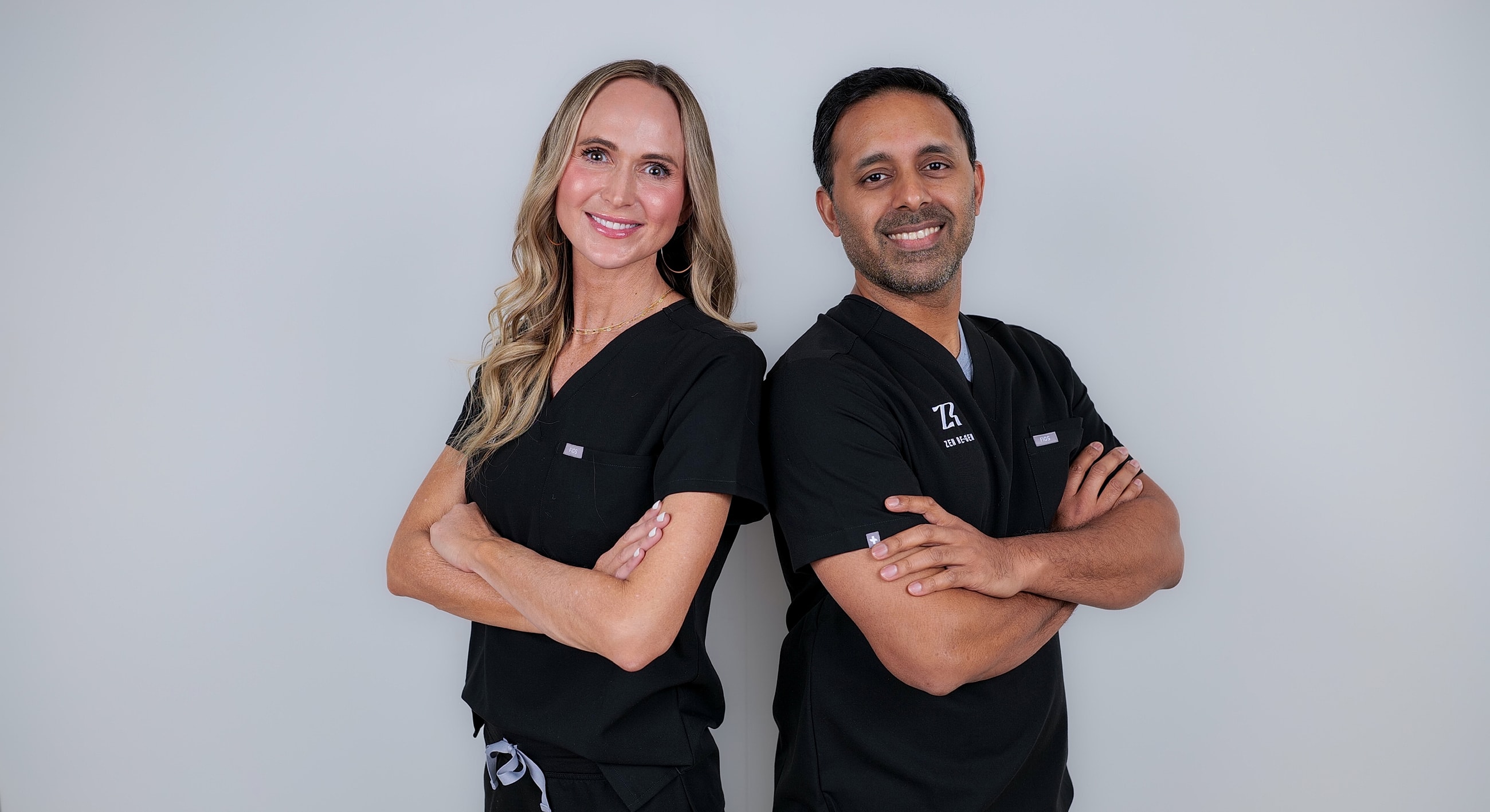 Two healthcare professionals posing confidently together.