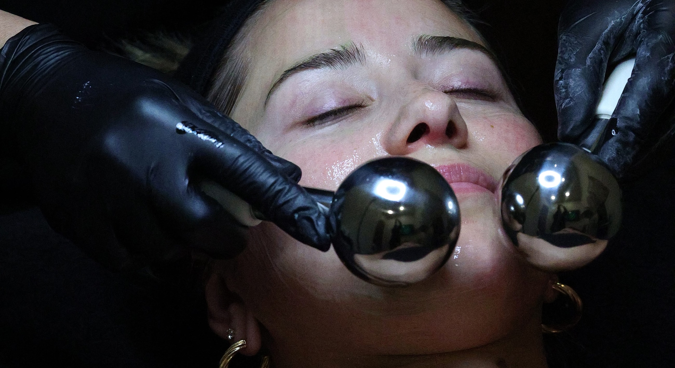 Facial treatment with beauty tools on a client.