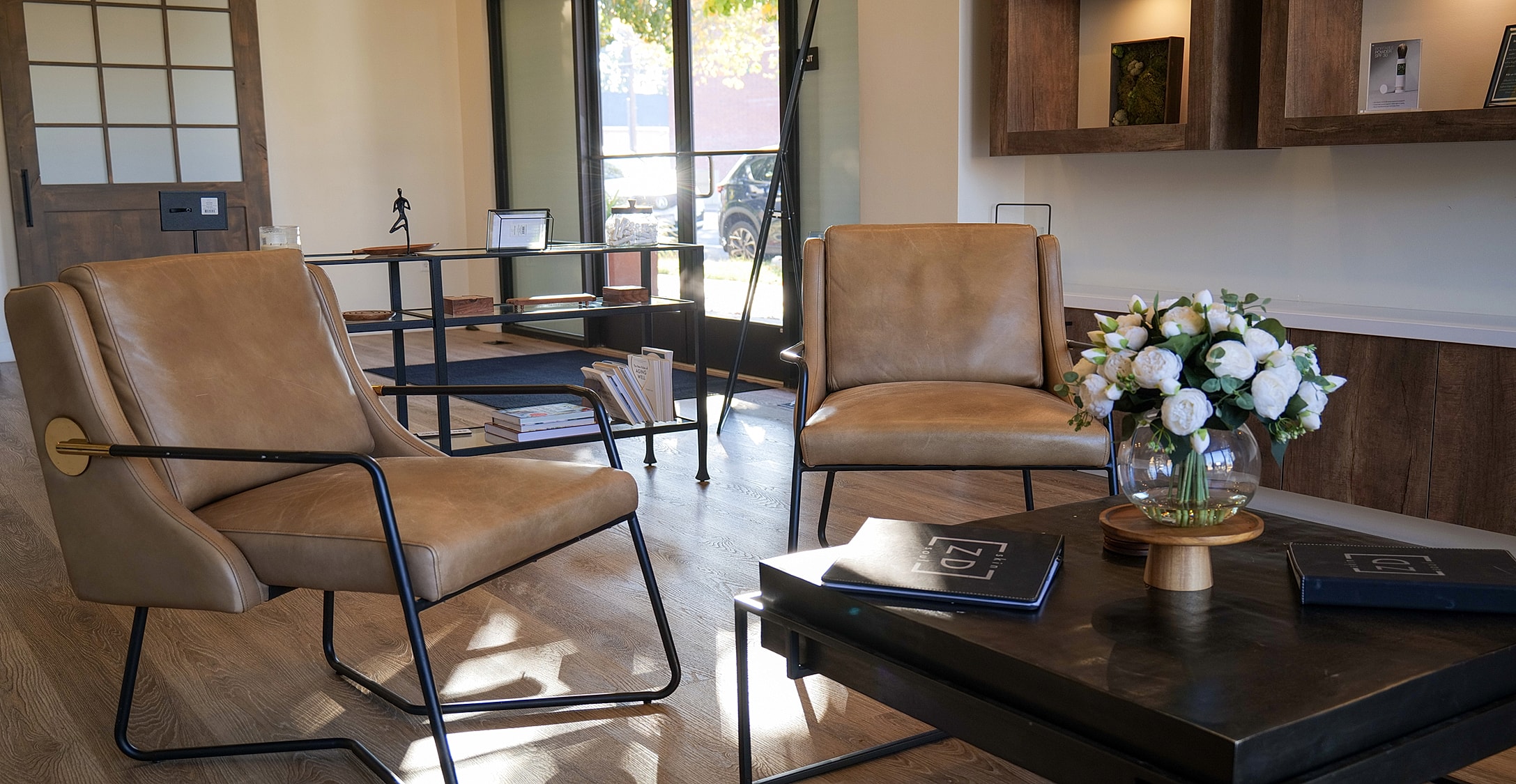 Modern seating area with floral arrangement.