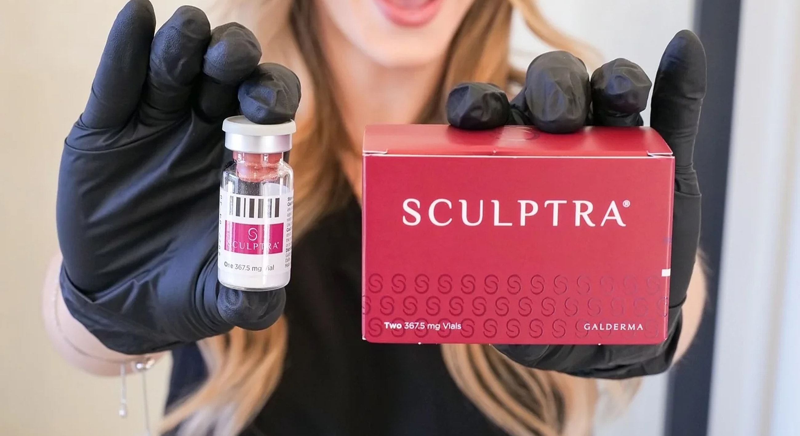 Sculptra vial and packaging held by gloved hands.
