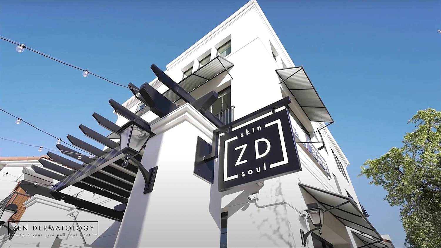 Zen Dermatology exterior with sign and clear sky.